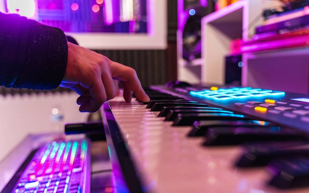 Hands on the studio keyboard